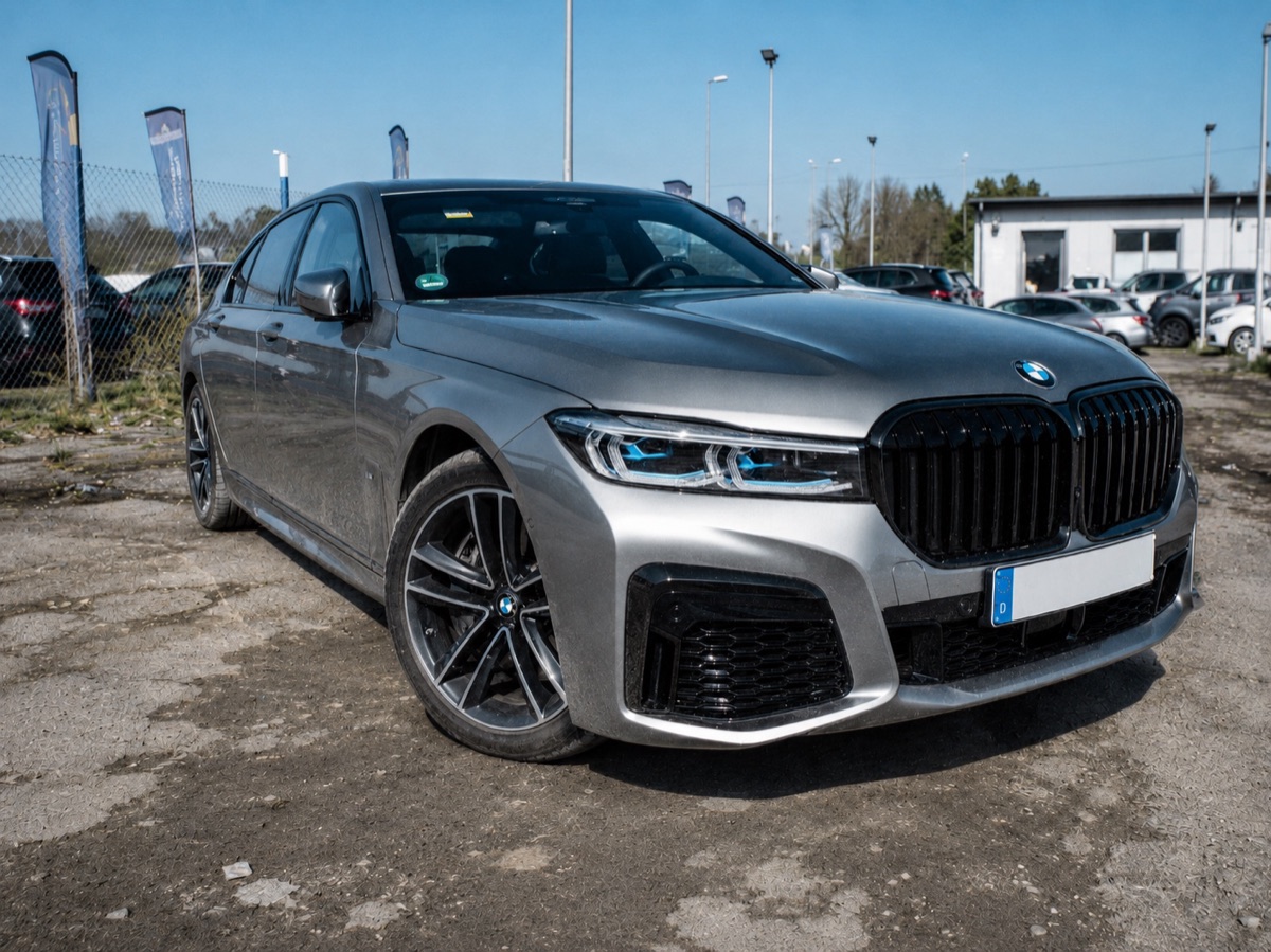 BMW photographed in a cluttered parking lot